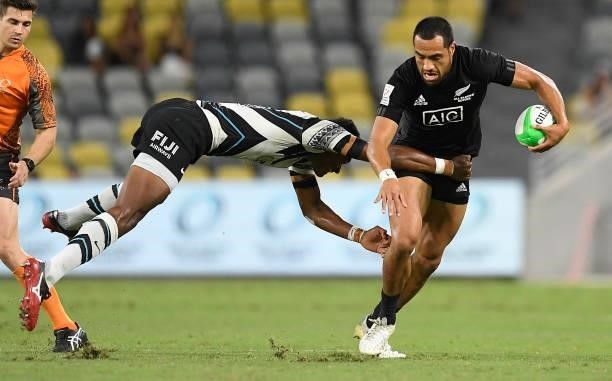 Sione Molia of New Zealand is tackled by Iosefo Masi of Fiji during the Oceania Sevens Challenge match between New Zealand and Fiji at Queensland...
