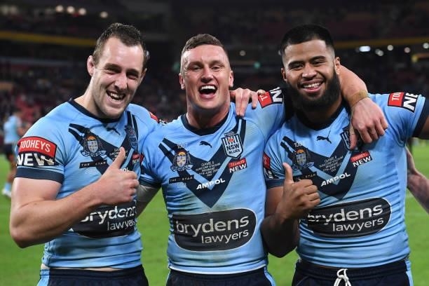 Isaah Yeo of the Blues, Jack Wighton of the Blues and Payne Haas of the Blues celebrate winning game two of the 2021 State of Origin series between...