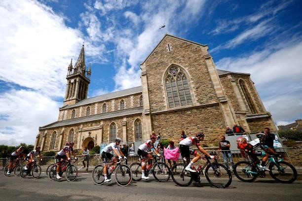 Tadej Pogačar of Slovenia and UAE-Team Emirates white best young jersey & The Peloton passing through l'église Notre-Dame in Plouguiel village...