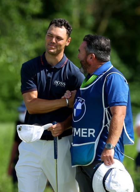 Martin Kaymer of Germany and his caddie Craig Connelly on the 18th green during the final round of The BMW International Open at Golfclub Munchen...