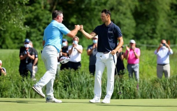 Martin Kaymer of Germany and Ryan Fox of New Zealand 18th green during the final round of The BMW International Open at Golfclub Munchen Eichenried...