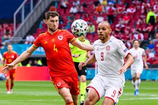 Martin Braithwaite of Denmark fights for the ball with Ben Davies of Wales during the UEFA Euro 2020 Championship Round of 16 match between Wales and...