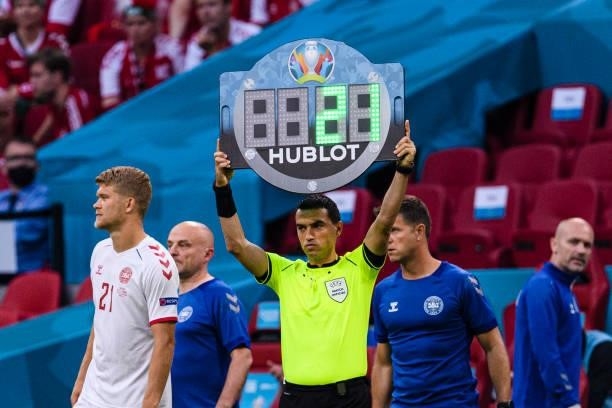 Referee Ovidiu Hategan shows a Hublot substitution board during the UEFA Euro 2020 Championship Round of 16 match between Wales and Denmark at Johan...