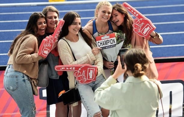 Beth Dobbin of Edinburgh AC poses for photographs with supporters during Day Three of the Muller British Athletics Championships at Manchester...
