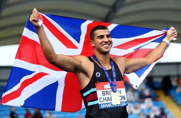 Adam Gemili of Blackheath poses for photographs after winning the Mens 200m Final on Day Three of the Muller British Athletics Championships at...