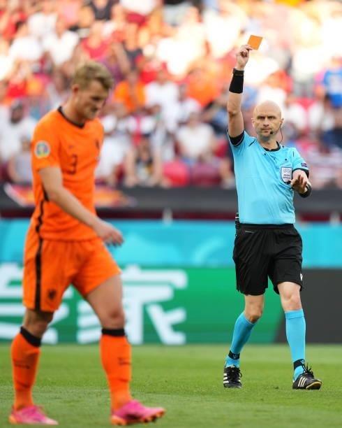Match Referee, Sergei Karasev shows a red card to Matthijs de Ligt of Netherlands after a VAR review during the UEFA Euro 2020 Championship Round of...