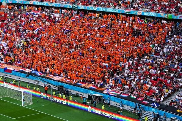Fans and supporters of the Netherlands with an advertisement of Thuisbezorgd.nl with rainbow accents during the UEFA Euro 2020: Round of 16 match...