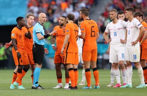 Memphis Depay and Daley Blind of Netherlands interacts with Match Referee, Sergei Karasev during the UEFA Euro 2020 Championship Round of 16 match...