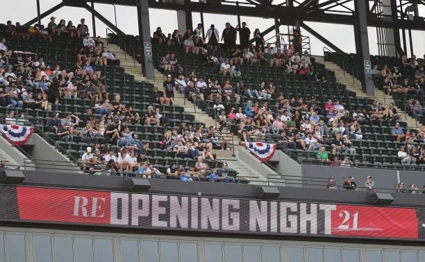 Fans sit in the upper deck as a sign proclaims ReOpening Night 21 as the Chicago White Sox take on the Seattle Mariners at Guaranteed Rate Field on...