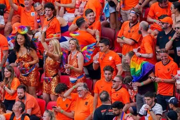 Supporters of the Netherlands wear rainbow colours on their outfits and hold rainbow flags during the UEFA Euro 2020: Round of 16 match between...