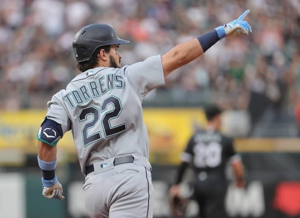 Luis Torrens of the Seattle Mariners celebrates his two run home run as he runs the bases against the Chicago White Sox at Guaranteed Rate Field on...