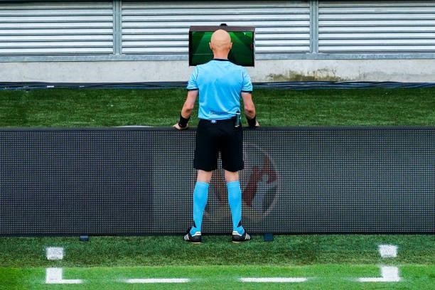 Referee Sergei Karasev checking the VAR for a direct red card for Matthijs de Ligt of the Netherlands during the UEFA Euro 2020: Round of 16 match...