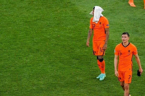Patrick van Aanholt of the Netherlands and Steven Berghuis of the Netherlands look disappointed after the UEFA Euro 2020: Round of 16 match between...