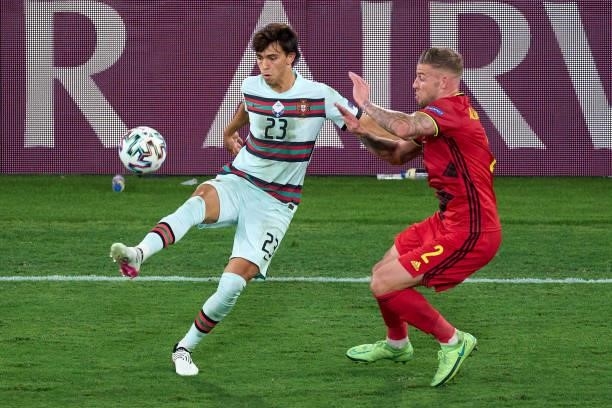 Toby Alderweireld of Belgium competes for the ball with Joao Felix of Portugal during the UEFA Euro 2020 Championship Round of 16 match between...