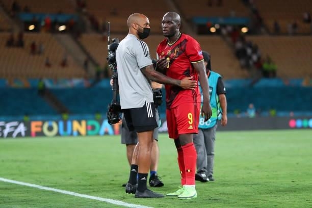 Romelu Lukaku of Belgium interacts with Thierry Henry, Assistant Coach of Belgium after the UEFA Euro 2020 Championship Round of 16 match between...