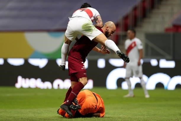 Wuilker Fariñez of Venezuela makes a save as Mikel Villanueva of Venezuela and Gianluca Lapadula of Peru fight for the ball during a Group B Match...