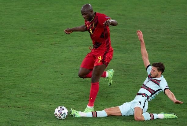 Romelu Lukaku of Belgium competes for the ball with Ruben Dias of Portugal during the UEFA Euro 2020 Championship Round of 16 match between Belgium...