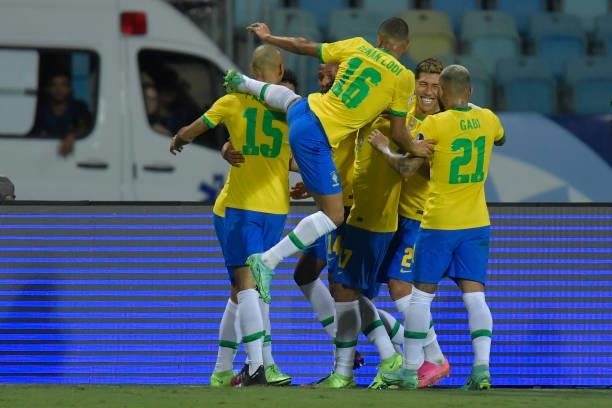 Eder Militao of Brazil celebrates with teammates after scoring the first goal of his team during a group B match between Brazil and Ecuador as part...