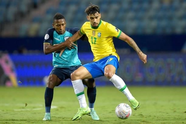 Pervis Estupiñan of Ecuador competes for the ball with Lucas Paqueta of Brazil during a group B match between Brazil and Ecuador as part of Copa...