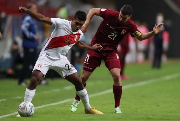 Raziel Garcia of Peru and Alexander Gonzalez of Venezuela fight for the ball during a Group B Match between Venezuela and Peru as part of Copa...