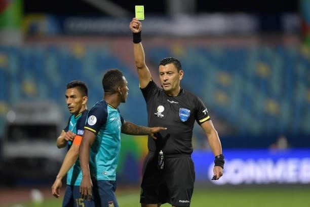 Referee Roberto Tobar shows a yellow card to Pervis Estupiñan of Ecuador during a group B match between Brazil and Ecuador as part of Copa America...