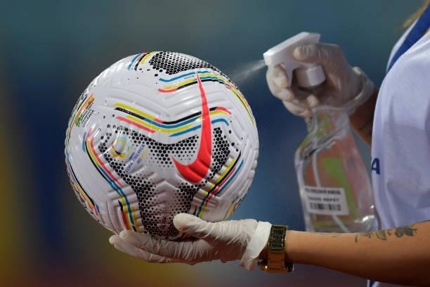 Copa America staff member disinfects a match ball prior a group B match between Brazil and Ecuador as part of Copa America Brazil 2021 at Estadio...