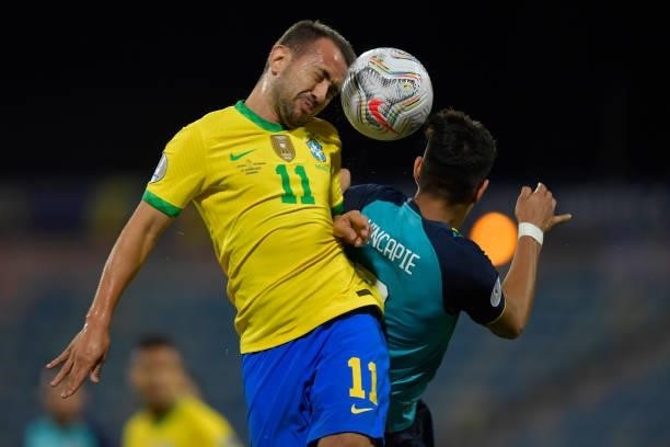 Everton Ribeiro of Brazil jumps for the ball with Piero Hincapie of Ecuador during a group B match between Brazil and Ecuador as part of Copa America...