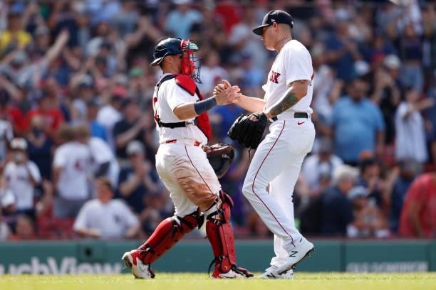 Yacksel Rios of the Boston Red Sox celebrates with Christian Vazquez after defeating the New York Yankees 9-2 at Fenway Park on June 27, 2021 in...