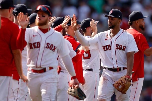 Xander Bogaerts of the Boston Red Sox celebrates with teammates after the Red Sox defeat the New York Yankees 9-2 at Fenway Park on June 27, 2021 in...