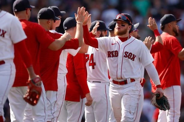 Alex Verdugo of the Boston Red Sox celebrates with teammates after the Red Sox defeat the New York Yankees 9-2 at Fenway Park on June 27, 2021 in...