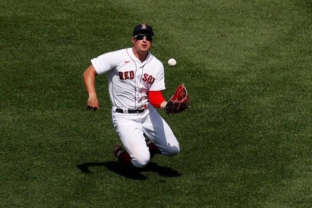 Hunter Renfroe of the Boston Red Sox rolls after catching a fly ball hit by Giancarlo Stanton of the New York Yankees during the sixth inning at...
