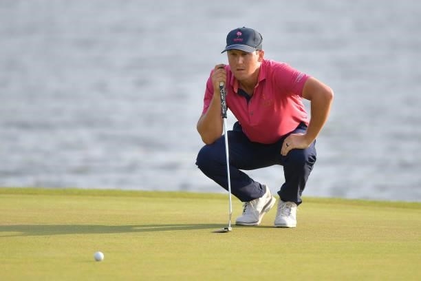 Kramer Hickok of the United States looks over his putt on the 17th green in the third playoff hole during the final round of the Travelers...