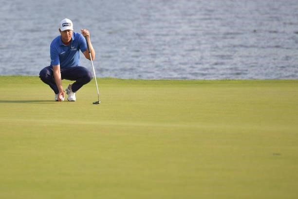 Harris English of the United States lines up a putt on the 17th green in the third playoff hole during the final round of the Travelers Championship...