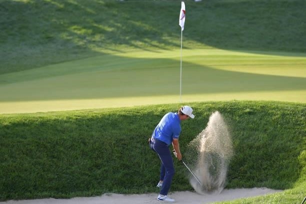 Harris English of the United States plays a shot from a bunker on the 18th hole in the second playoff hole against Kramer Hickok of the United States...