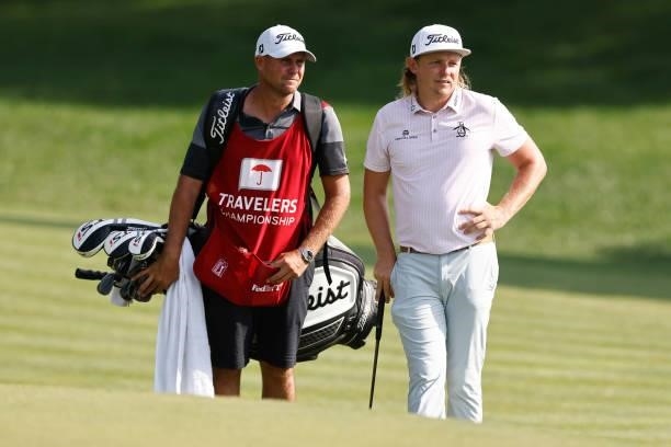 Cameron Smith of Australia talks with his caddie on the 15th hole during the final round of the Travelers Championship at TPC River Highlands on June...