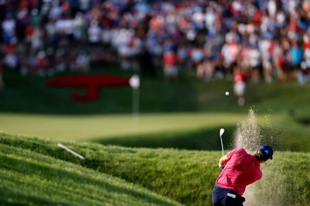 Kramer Hickok of the United States plays a shot from a bunker on the 18th hole during the first playoff hole against Harris English of the United...
