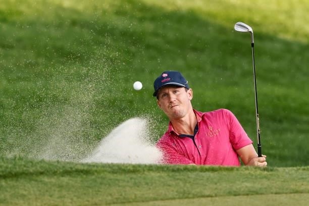 Kramer Hickok of the United States plays a shot from a bunker on the 18th hole during the fourth playoff hole against Harris English of the United...