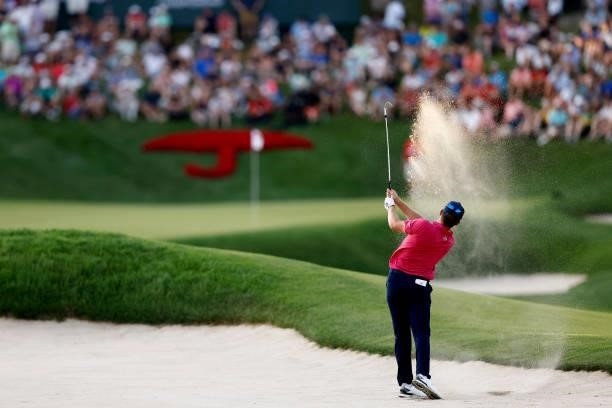 Kramer Hickok of the United States plays a shot from a bunker on the 18th hole during the sixth playoff hole against Harris English of the United...