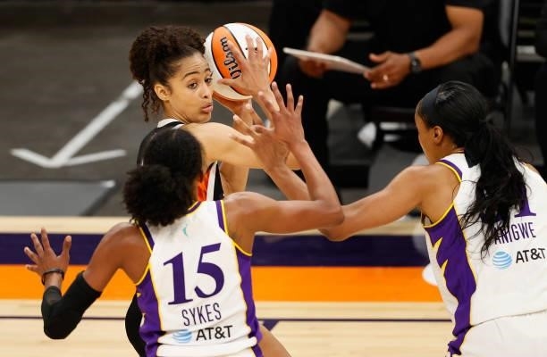 Skylar Diggins-Smith of the Phoenix Mercury looks to pass around Brittney Sykes and Kristine Anigwe of the Los Angeles Sparks during the second half...