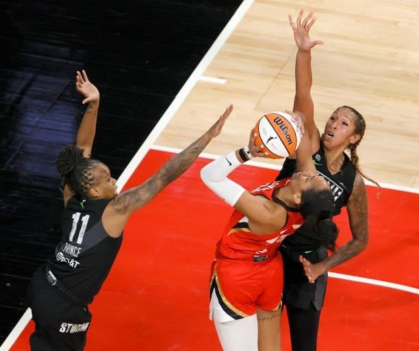 Mercedes Russell of the Seattle Storm blocks a shot by A'ja Wilson of the Las Vegas Aces as Epiphanny Prince of the Storm defends during their game...