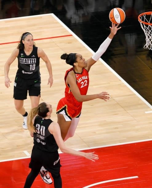 Ja Wilson of the Las Vegas Aces drives to the basket between Sue Bird and Breanna Stewart of the Seattle Storm during their game at Michelob ULTRA...