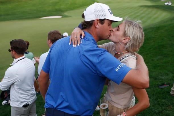 Harris English of the United States kisses his wife, Helen Marie Bowers, after winning the Travelers Championship in the eighth playoff hole over...