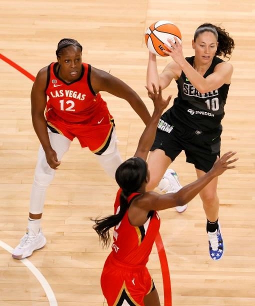Sue Bird of the Seattle Storm passes under pressure from Chelsea Gray and Jackie Young of the Las Vegas Aces during their game at Michelob ULTRA...