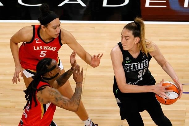 Breanna Stewart of the Seattle Storm is guarded by Dearica Hamby and Riquna Williams of the Las Vegas Aces during their game at Michelob ULTRA Arena...