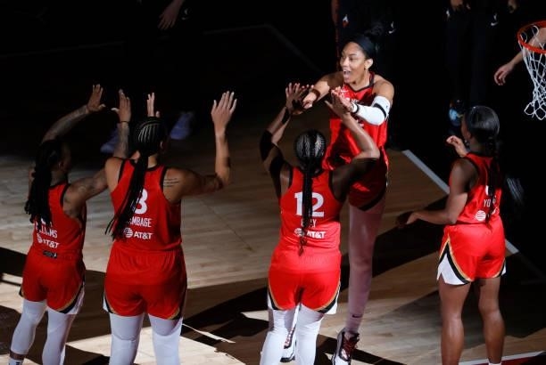 Ja Wilson of the Las Vegas Aces is greeted on the court by teammates Riquna Williams, Liz Cambage, Chelsea Gray and Jackie Young during player...