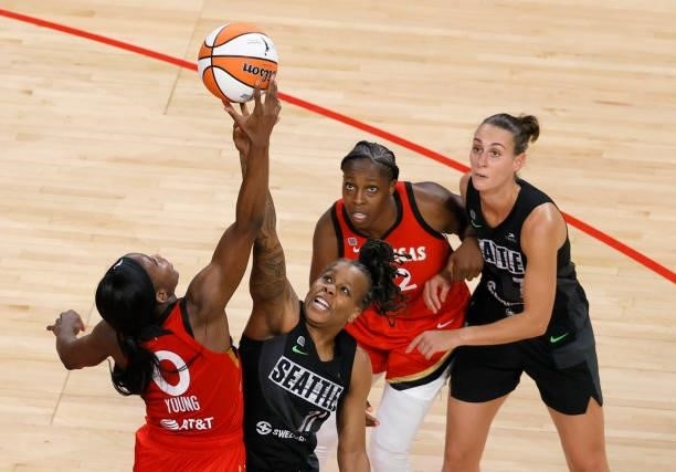 Jackie Young of the Las Vegas Aces and Epiphanny Prince of the Seattle Storm vie for a jump ball as Chelsea Gray of the Aces and Stephanie Talbot of...