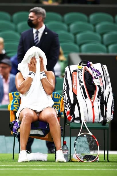 Heather Watson of Great Britain reacts as she sits down during a change of ends in her Ladies' Singles First Round match against Kristie Ahn of The...
