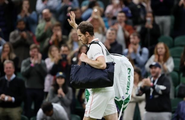 Andy Murray of Great Britain waves to the fans as he walks off the court after winning his Men's Singles First Round match against Nikoloz...