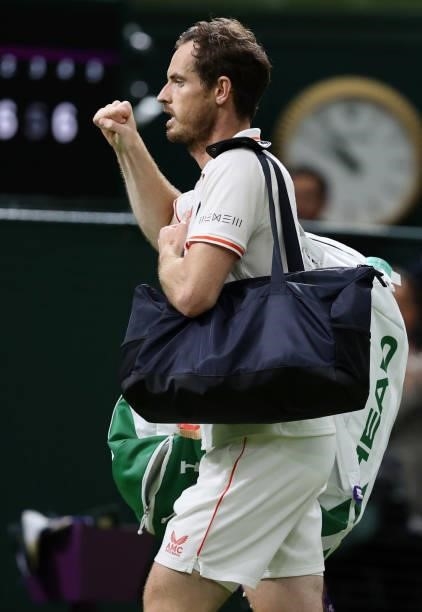 Andy Murray of Great Britain celebrates as he walks off the court after winning his Men's Singles First Round match against Nikoloz Basilashvili of...
