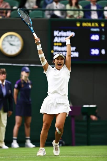 Kristie Ahn of The United States celebrates after winning match point in her Ladies' Singles First Round match against Heather Watson of Great...